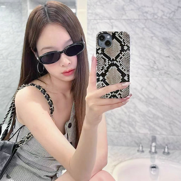 Model holding Printed Python Case. High-fashion snake motif on a flexible and resilient silicone frame.