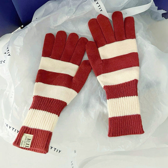 Flat lay bold stripe knit gloves in red and cream with ribbed cuffs; warm knit for daily winter use.