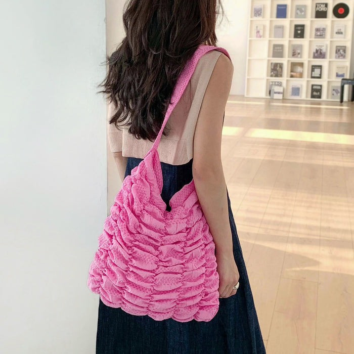 Model carrying a pink Bubble Pleat Bag , easy for commuting and weekends.