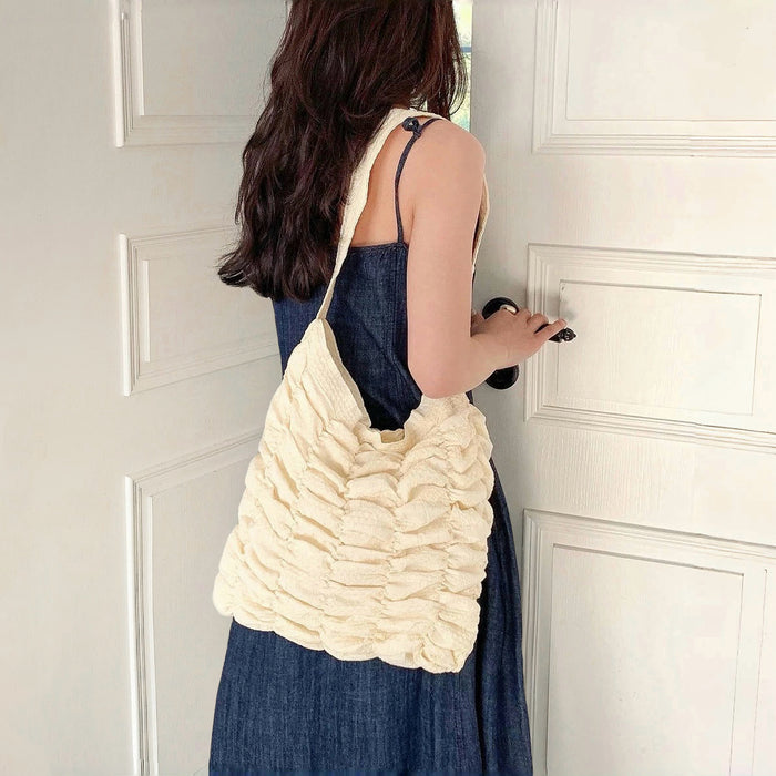 Model carrying a white polyester bag on the shoulder, great for daily carry and travel.