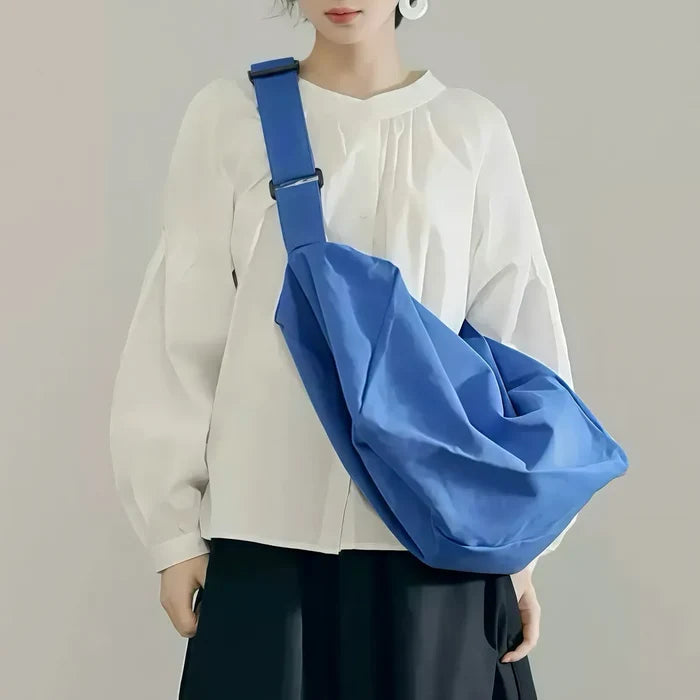 Model carrying a blue  Chic Day Hobo Bag as crossbody, great for daily carry and travel.