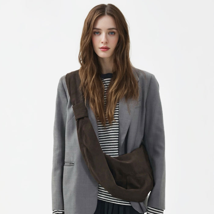 Model wearing the dark brown corduroy crescent bag as a crossbody.