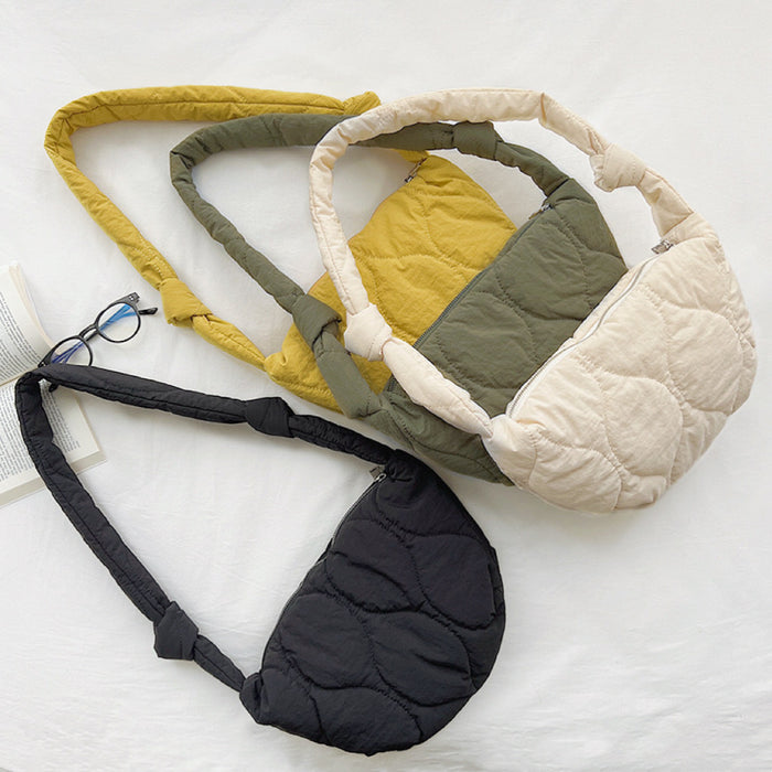 Top view of four color of the crescent bags, showing he high-quality quilted stitching and soft-touch fabric.