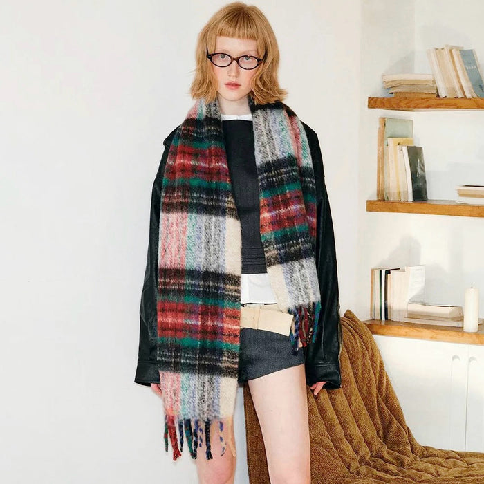 Model wearing Crimson Meadow Plaid Scarf: Wool-acrylic blend with red, green, black, and cream plaid.