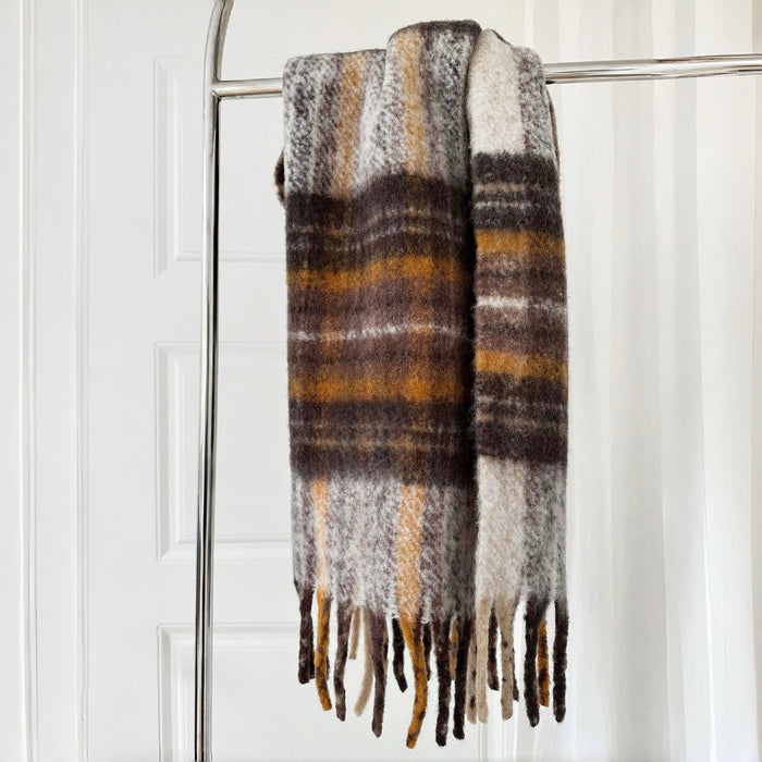 Flat lay of Crimson Meadow Plaid Scarf in brown and yellow, ideal for everyday styling and weekend outings.
