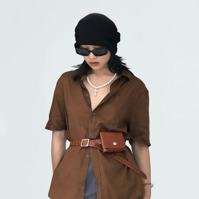 Model wearing the tan crocodile leather belt with pouch, featuring a casual chic.