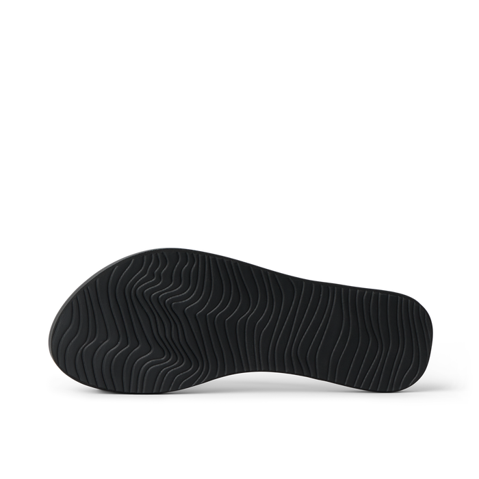 Bottom sole of Cushion Slim black women's footwear showing textured water-friendly rubber grip for beach comfort and durability