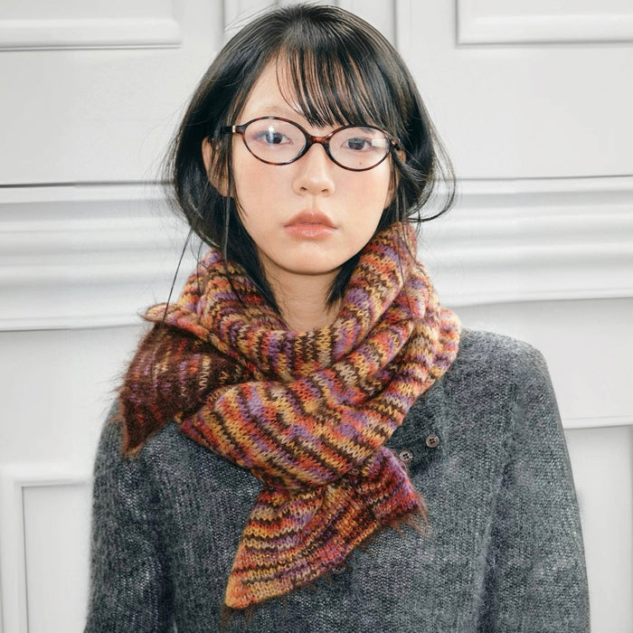 Model wearing Dual-Sided Aurora Texture Soft Scarf, a wool blend scarf with multicolored stripes in brown.