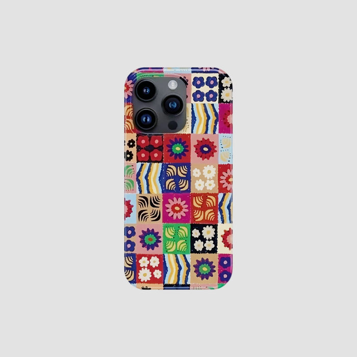 Silicone iPhone case with colorful floral patchwork design. Precise camera cutout for cottagecore fashion style.