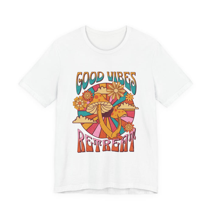 A women white short-sleeve crewneck t-shirt featuring a colorful retro-style graphic with the words 'GOOD VIBES RETREAT' and a psychedelic mushroom, sun, and flower design | AH Urban Wear PK