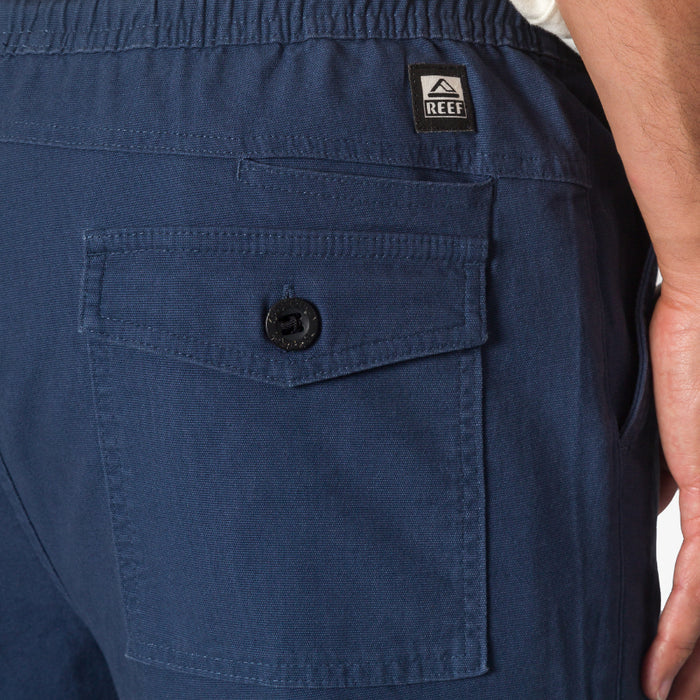 Close-up of the back pocket and waistband details on the Matthew Twill Pant in navy blue, men's apparel.