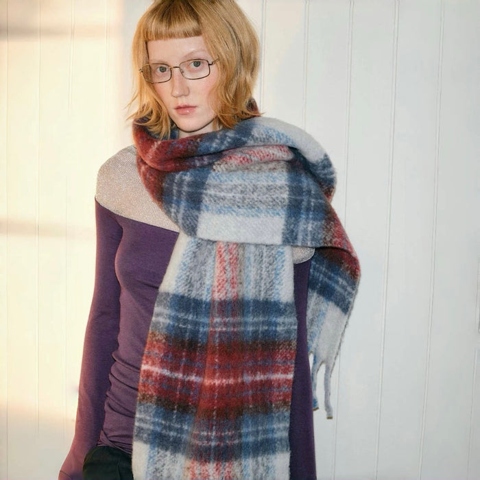 Model wearing a plaid wool scarf Midnight Blaze Plaid Scarf, easy for weekend styling and gifting.