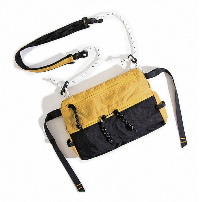 Folded view of yellow and black water-resistant nylon sling bag, multi-pocket tactical design.