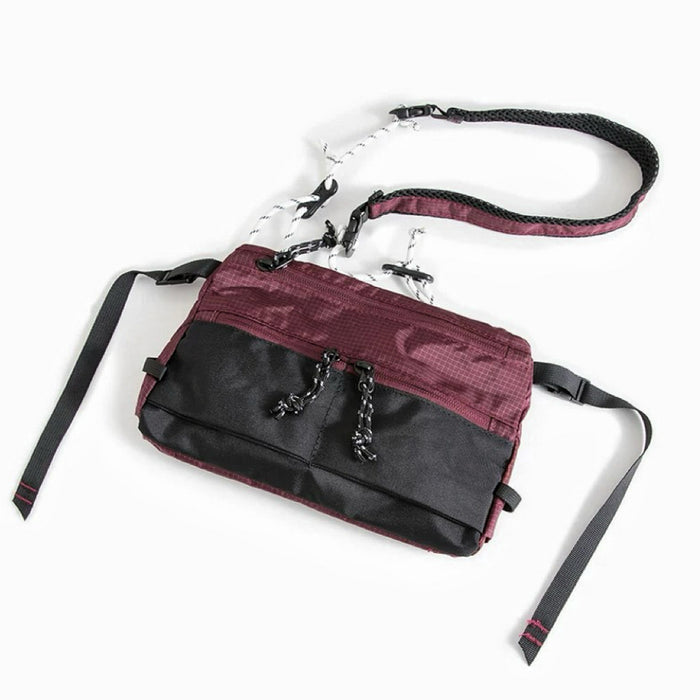 Front view of burgundy outdoor leisure sling bag with adjustable strap, compact travel companion.