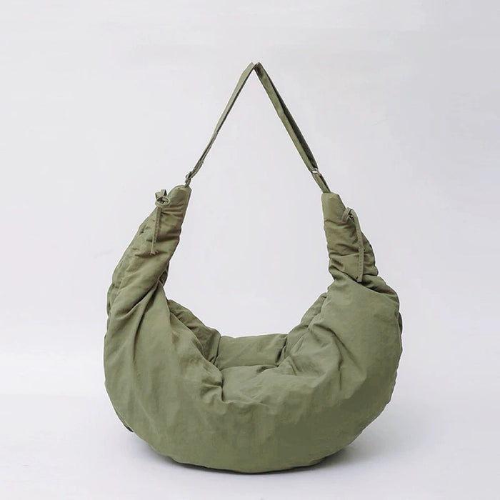 Front view of the olive green puffy crescent bag with a comfortable wide shoulder strap.