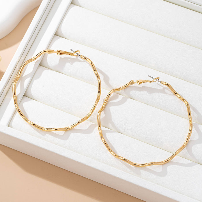 Oversized Hammered Wavy Hoop Earrings | 80E61830 JOSSLYN by wall to wall- Tilden Co.