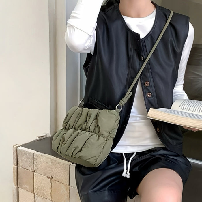 Model carrying a olive green Pleated Cloud Bag as crossbody, easy for commuting and weekends.