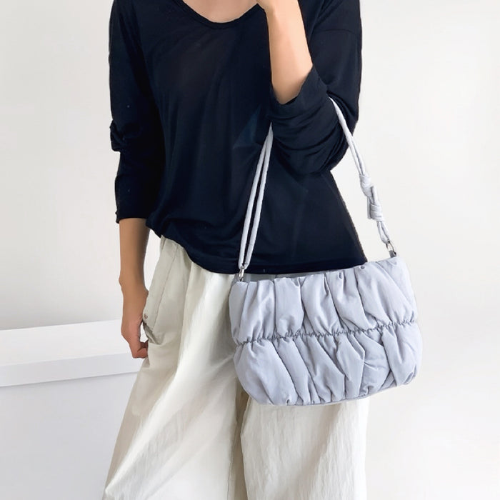 Model carrying a blue Pleated Cloud Bag handheld, ideal for city walks and gifting.