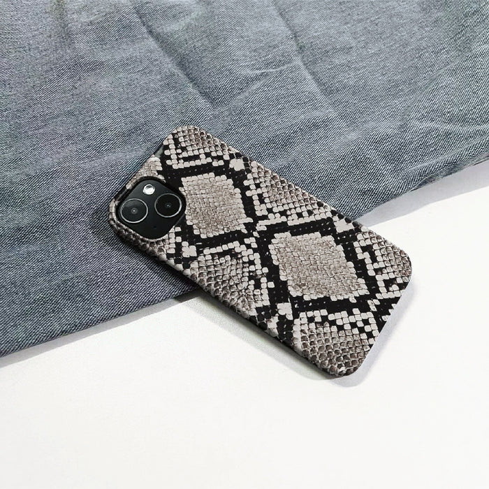 Realistic python skin motif on a durable silicone iPhone case. High-fashion animal print accessory.