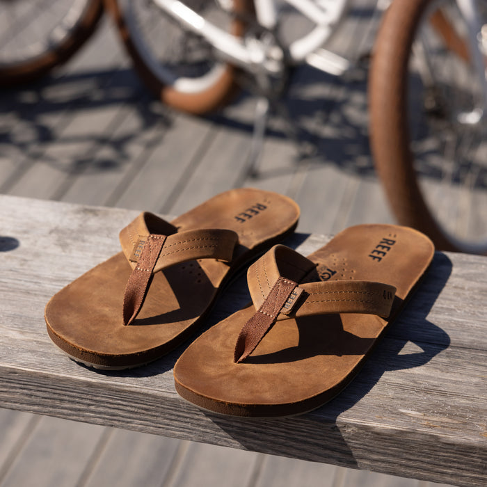Reef Draftsmen men's brown sandals facing forward, showing soft-rebound cushioning and durable water-friendly straps.