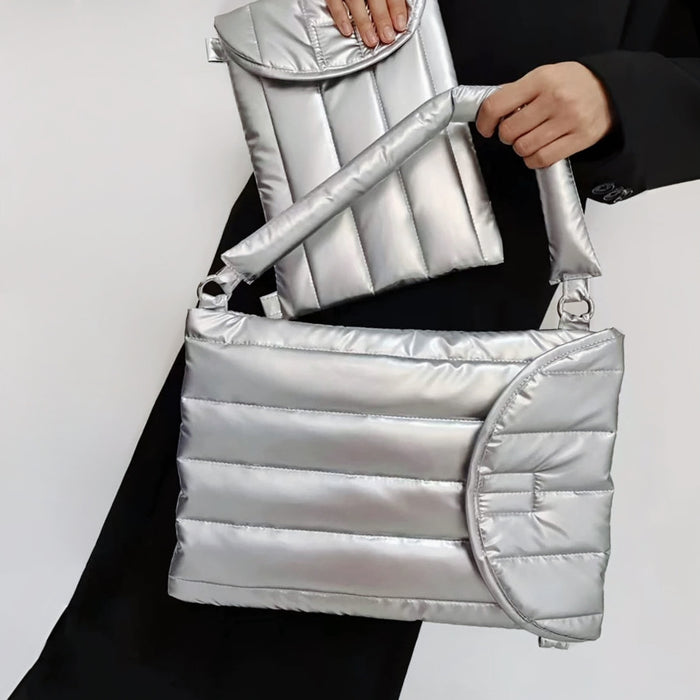 Model carrying a silver polyester bag handheld, great for daily carry and travel.