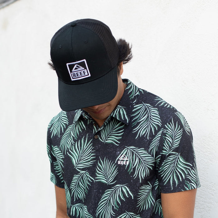 Man wearing a black Townsend Hat facing downward, highlighting comfort and surf-inspired beach apparel style.