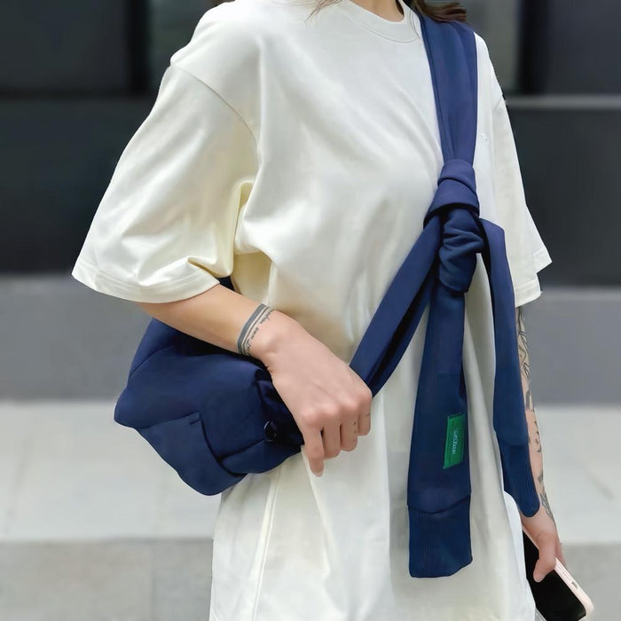 Model carrying a Twist & Tie Sleeve Bag as crossbody, ideal for city walks and gifting.