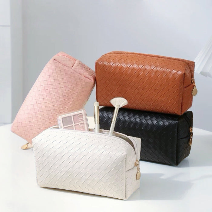 Front view of Four woven PU leather makeup bags: pink, brown, black, and white.