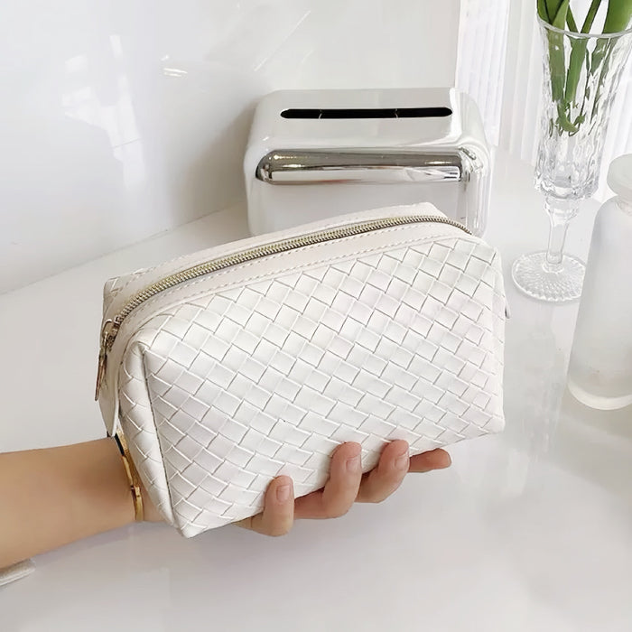 Model holding a white makeup bag in hand, great for on-the-go touch-ups.
