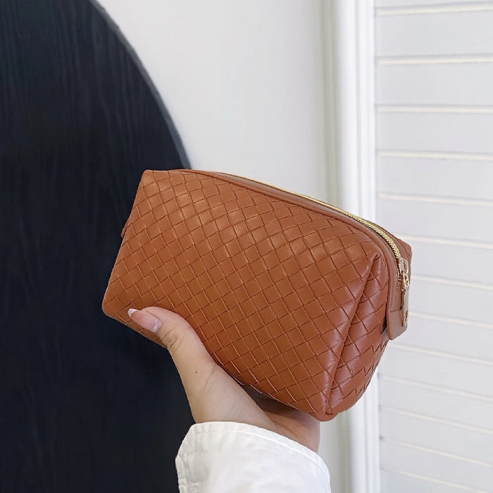 Model holding a brown makeup bag in hand, ideal for daily makeup essentials.